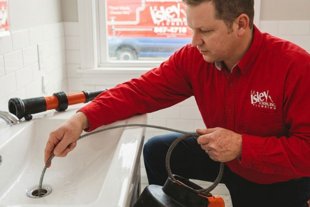 Isley Plumbing employee working on a clogged drain